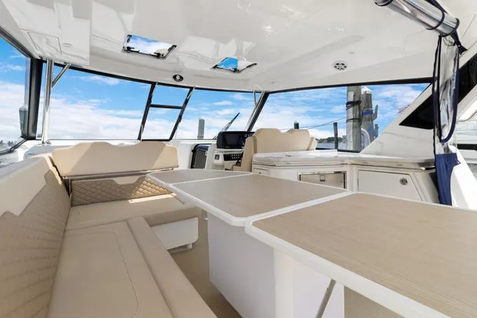 Escape Yacht Photos Pics Interior of 2022 Aquila 36 Sport yacht with modern seating and table setup.