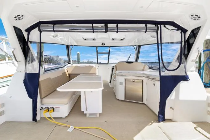 Escape Yacht Photos Pics 2022 Aquila 36 Sport yacht interior with seating, table, and kitchenette.