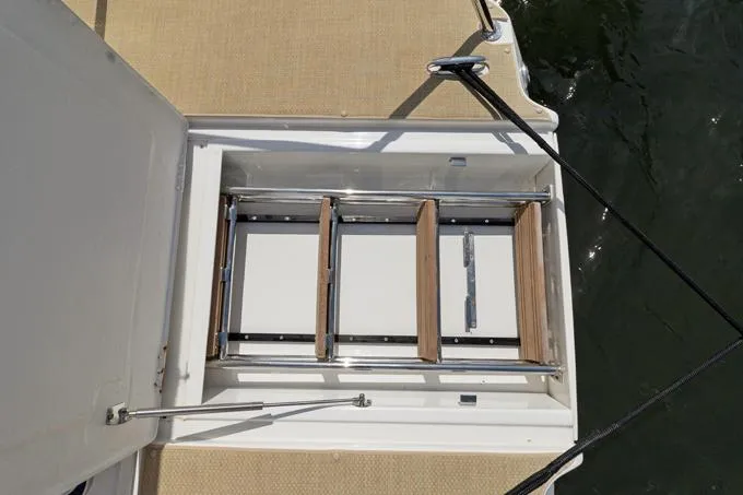 Escape Yacht Photos Pics Aquila 36 Sport 2022 boat ladder, retracted on deck, near water.