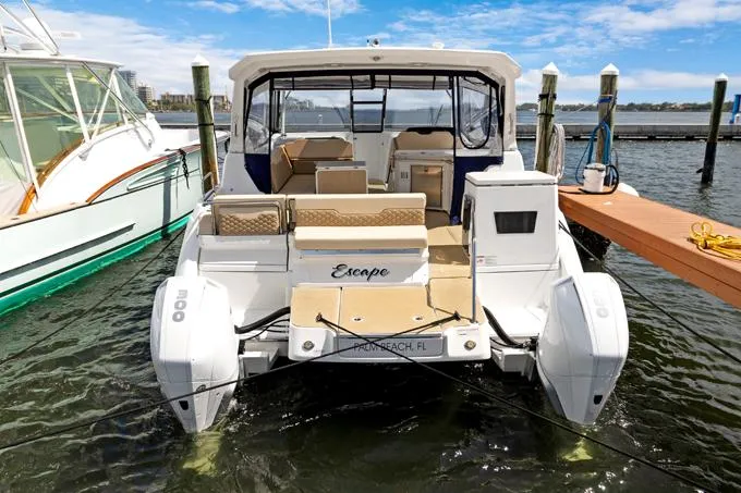 Escape Yacht Photos Pics Aquila 36 Sport 2022 boat docked, rear view, with "Escape" nameplate, Palm Beach, FL.
