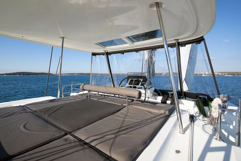  Yacht Photos Pics Luxurious 2022 Lagoon 500 catamaran deck with sunbathing area and ocean view.