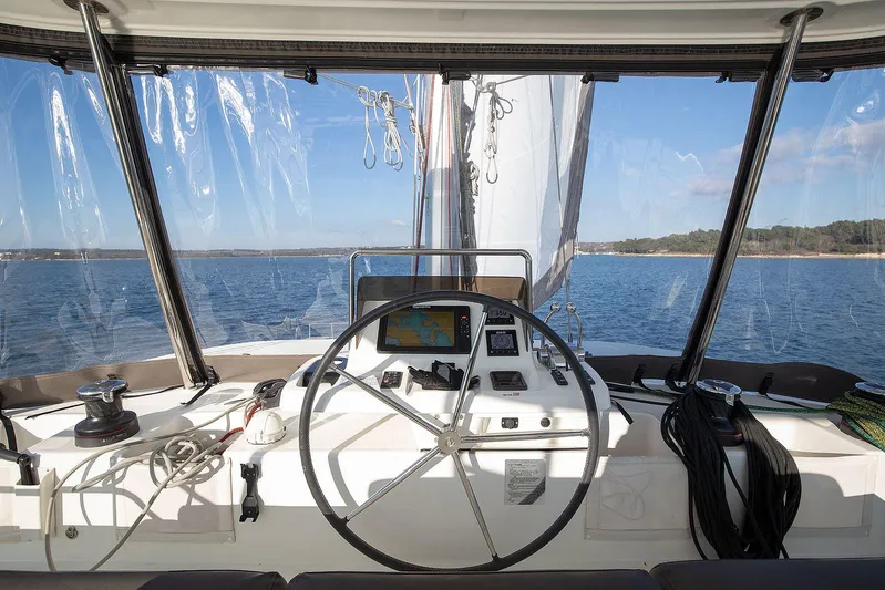  Yacht Photos Pics Cockpit view of 2022 Lagoon 500 catamaran sailing on open water.