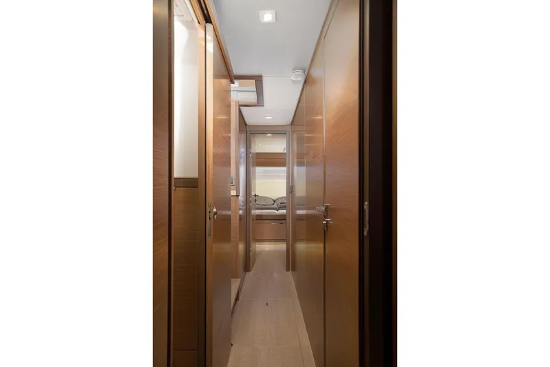  Yacht Photos Pics Interior hallway of 2022 Lagoon 500 yacht, featuring sleek wooden design and modern lighting.
