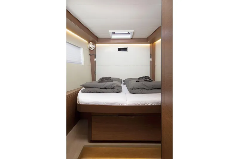  Yacht Photos Pics Luxurious cabin interior of 2022 Lagoon 500 yacht with cozy bedding and modern design.