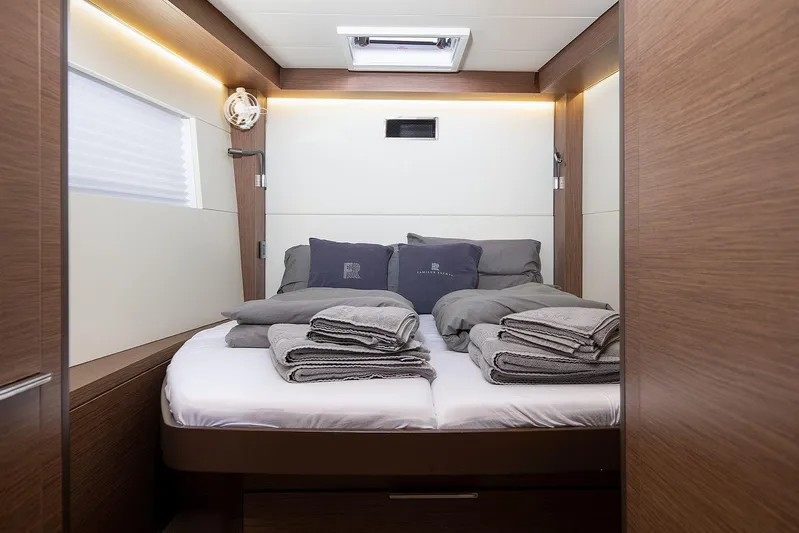  Yacht Photos Pics Luxurious cabin interior of 2022 Lagoon 500 yacht with neatly arranged bedding.