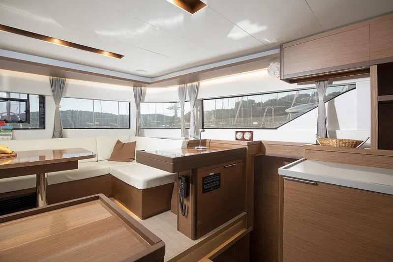  Yacht Photos Pics Luxurious interior of 2022 Lagoon 500 yacht with modern wood finishes and ample seating.