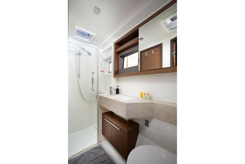  Yacht Photos Pics Modern bathroom in 2022 Lagoon 500 yacht with sleek design and wooden accents.