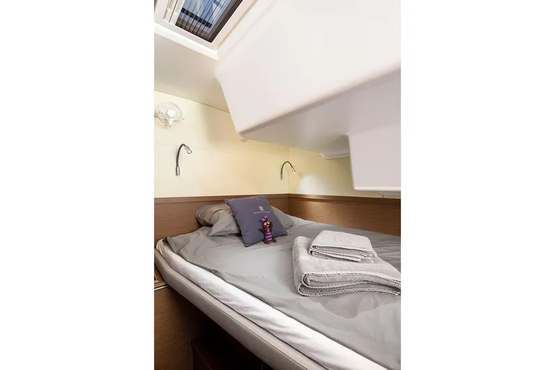  Yacht Photos Pics Cozy cabin interior of 2022 Lagoon 500 yacht with bed and skylight.