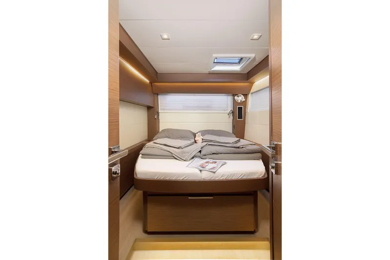  Yacht Photos Pics Luxurious cabin interior of 2022 Lagoon 500 yacht with cozy bed and modern design.