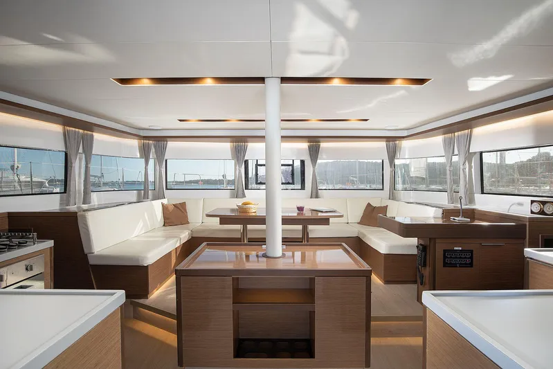  Yacht Photos Pics Luxurious interior of 2022 Lagoon 500 catamaran with modern furnishings and panoramic windows.