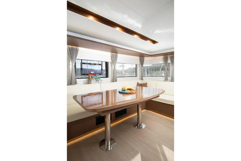  Yacht Photos Pics Luxurious interior of 2022 Lagoon 500 yacht with elegant dining area and panoramic windows.