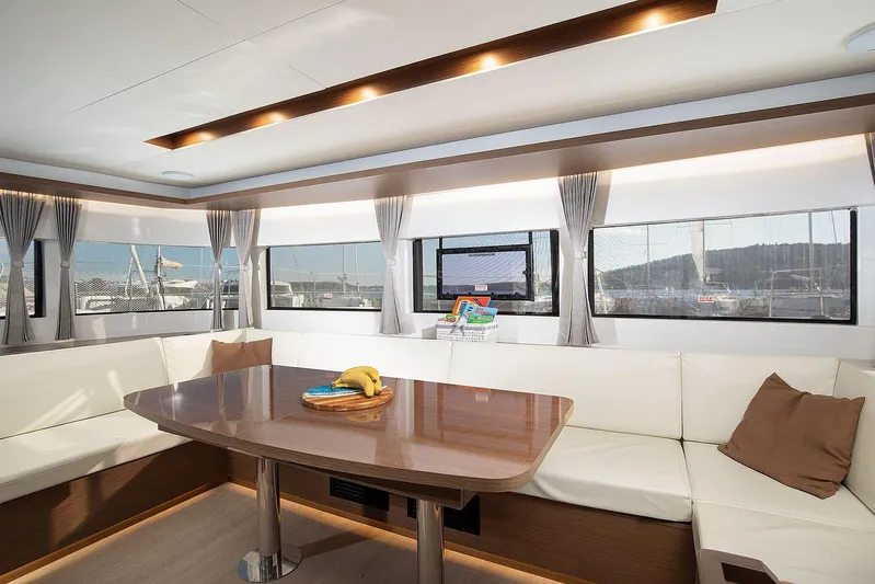  Yacht Photos Pics Luxurious interior of 2022 Lagoon 500 yacht with elegant seating and dining area.