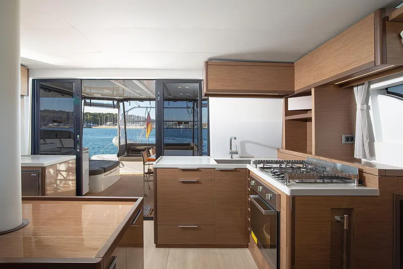  Yacht Photos Pics Modern kitchen interior on 2022 Lagoon 500 yacht with ocean view.