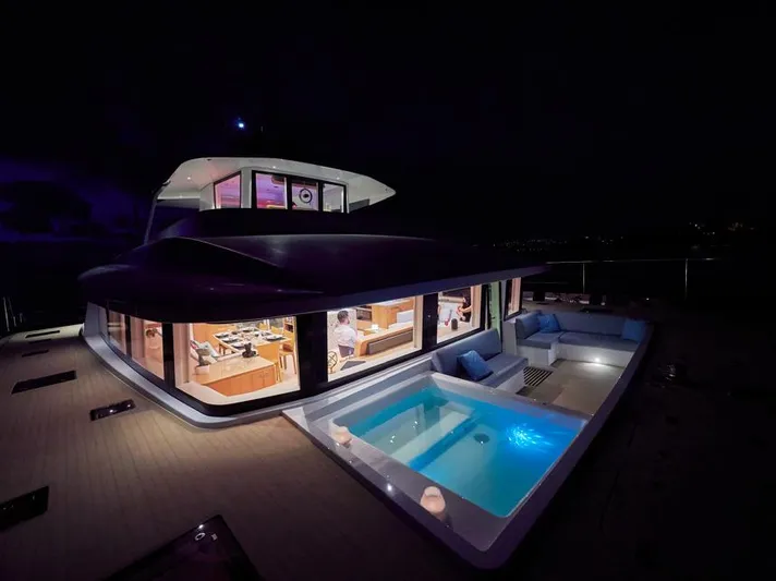 Long Island 78 Yacht Photos Pics Luxurious 2026 JFA Yachts Long Island 78 at night with illuminated interiors and pool.