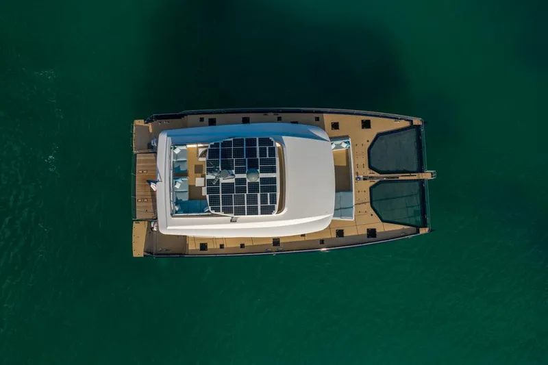 Long Island 78 Yacht Photos Pics Aerial view of 2026 JFA Yachts Long Island 78 catamaran on green water.