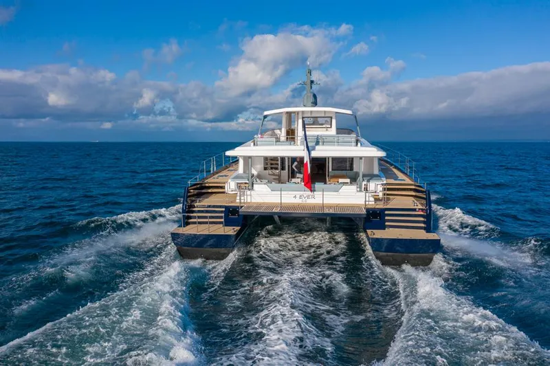 Long Island 78 Yacht Photos Pics 2026 JFA Yachts Long Island 78 catamaran cruising on open sea under blue sky.