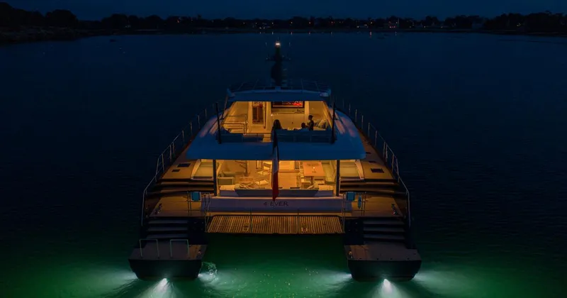 Long Island 78 Yacht Photos Pics Luxurious 2026 JFA Yachts Long Island 78 illuminated at night on calm waters.