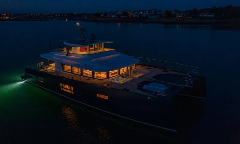 Long Island 78 Yacht Photos Pics Luxurious 2026 JFA Yachts Long Island 78 illuminated at night on calm waters.
