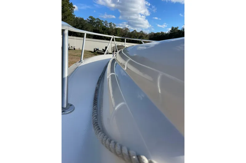 Steph-lo Yacht Photos Pics 2004 SeaVee 320i Cuddy boat deck with railing and rope under blue sky.