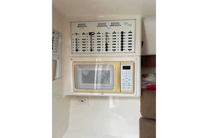 Steph-lo Yacht Photos Pics 2004 SeaVee 320i Cuddy interior with control panel and microwave.