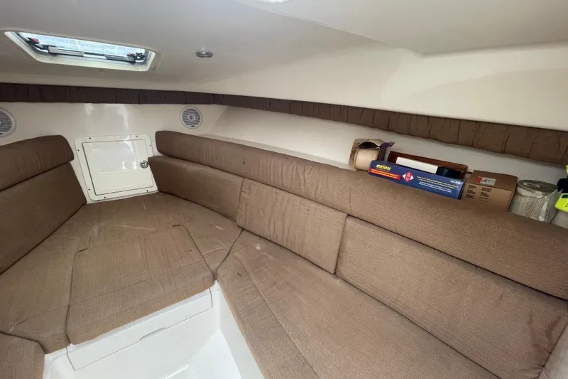 Steph-lo Yacht Photos Pics 2004 SeaVee 320i Cuddy interior with brown seating and storage space.