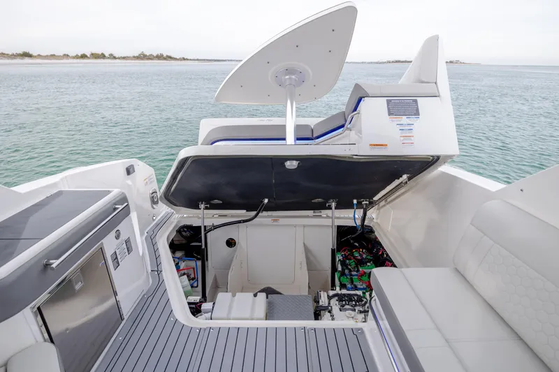  Yacht Photos Pics 2020 Sea Ray Sundancer 320 Outboard boat interior with open engine compartment, docked by the water.