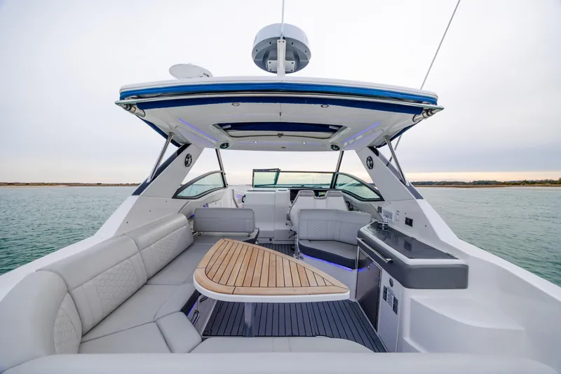  Yacht Photos Pics 2020 Sea Ray Sundancer 320 Outboard interior with seating and table on open water.