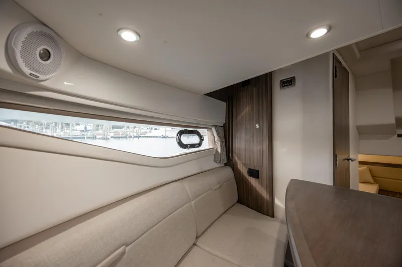  Yacht Photos Pics 2020 Sea Ray Sundancer 320 Outboard cabin interior with beige seating and wood accents.