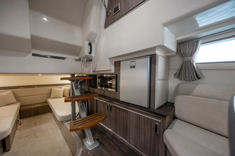  Yacht Photos Pics 2020 Sea Ray Sundancer 320 Outboard interior with modern seating and compact kitchenette.