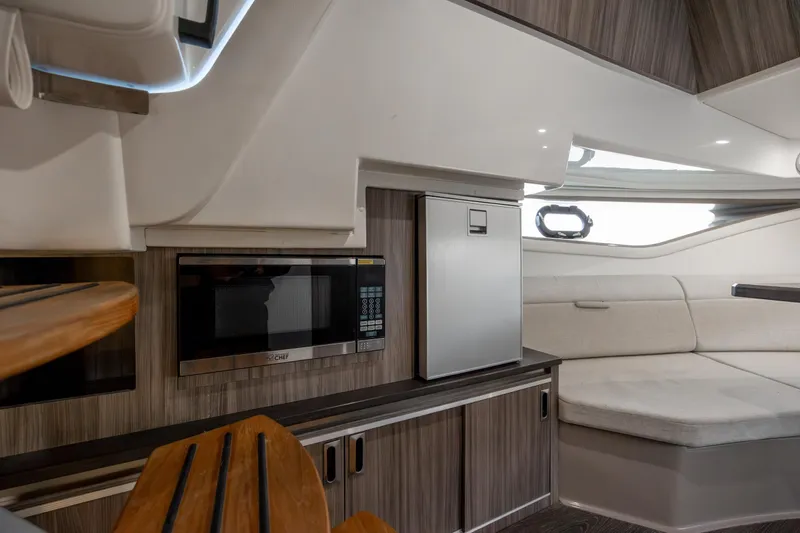  Yacht Photos Pics 2020 Sea Ray Sundancer 320 Outboard interior with kitchenette and seating area.