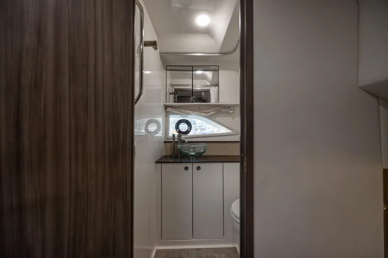  Yacht Photos Pics 2020 Sea Ray Sundancer 320 Outboard interior bathroom with modern fixtures and wood accents.