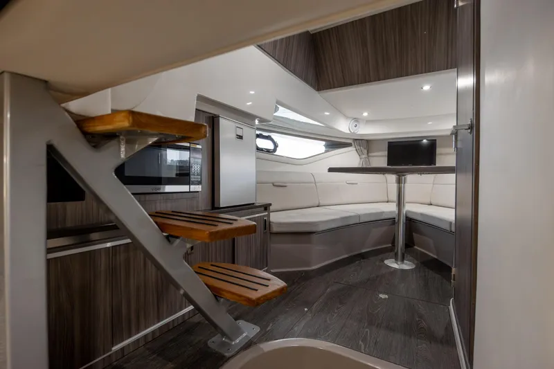  Yacht Photos Pics Interior of 2020 Sea Ray Sundancer 320 Outboard, featuring modern seating and wooden accents.