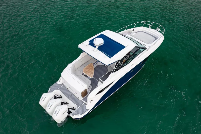  Yacht Photos Pics 2020 Sea Ray Sundancer 320 Outboard cruising on clear green water.