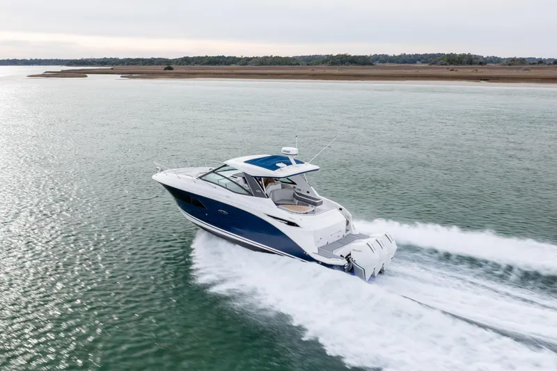  Yacht Photos Pics 2020 Sea Ray Sundancer 320 Outboard cruising on open water, showcasing sleek design and performance.