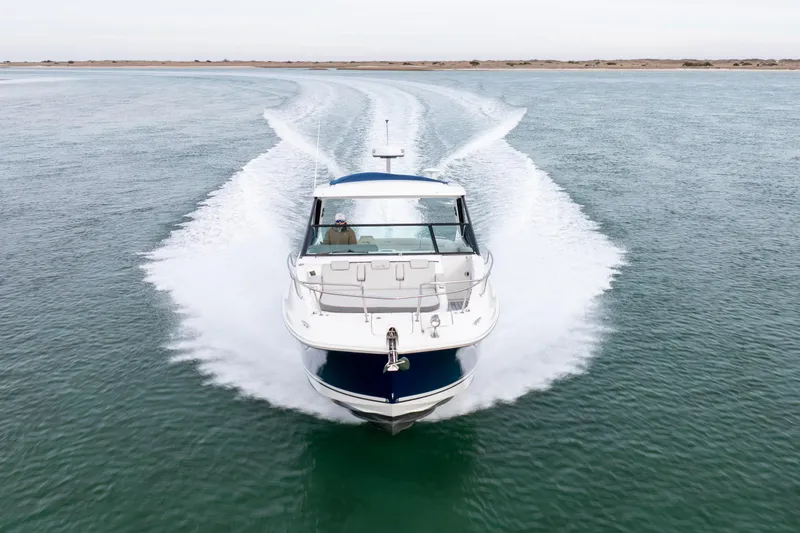  Yacht Photos Pics 2020 Sea Ray Sundancer 320 Outboard cruising on open water, creating a dynamic wake.