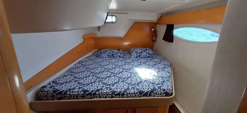  Yacht Photos Pics Cozy cabin interior of 2008 Fountaine Pajot Orana 44 Grand Large with patterned bedding.