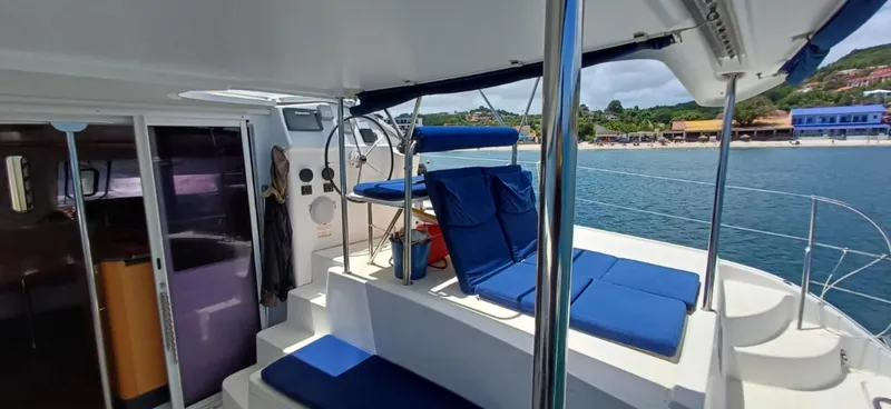  Yacht Photos Pics 2008 Fountaine Pajot Orana 44 Grand Large catamaran with blue seating, docked by the shore.