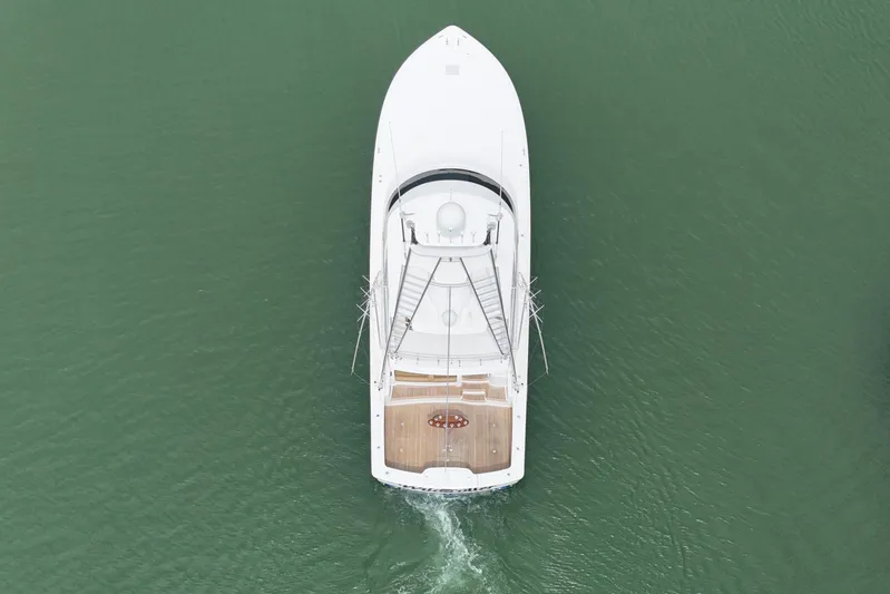 Wildcatter Yacht Photos Pics Aerial view of 2017 Viking 55 Convertible yacht cruising on green water.