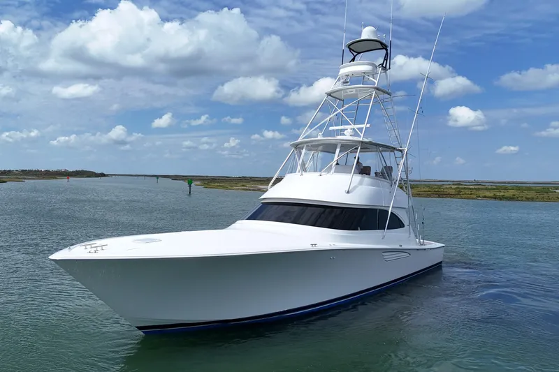 Wildcatter Yacht Photos Pics 2017 Viking 55 Convertible yacht cruising on a calm waterway under a blue sky.