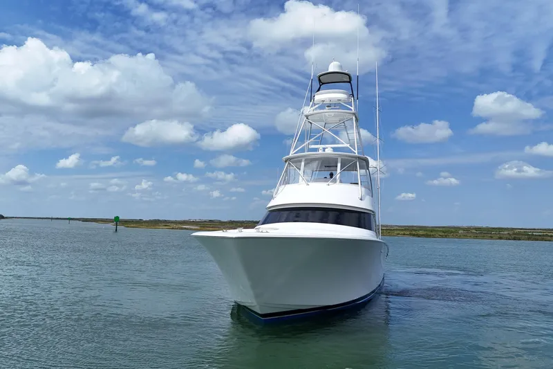 Wildcatter Yacht Photos Pics 2017 Viking 55 Convertible yacht cruising on a calm, scenic waterway.