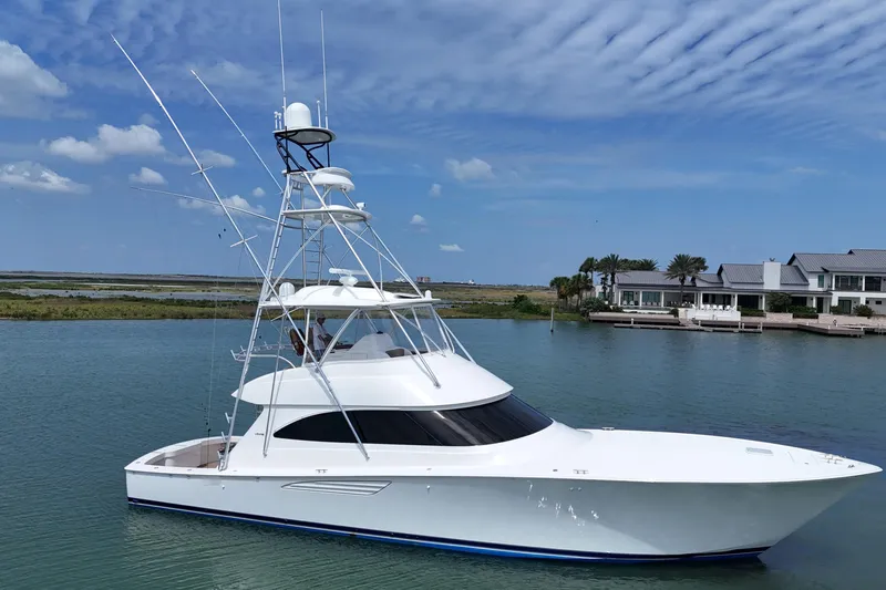 Wildcatter Yacht Photos Pics 2017 Viking 55 Convertible yacht on serene water near luxury waterfront homes.