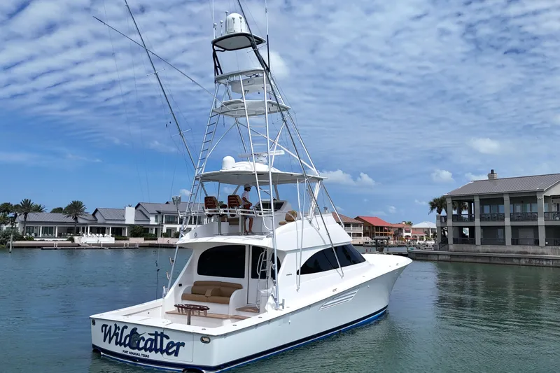 Wildcatter Yacht Photos Pics 2017 Viking 55 Convertible yacht docked in a serene marina setting.