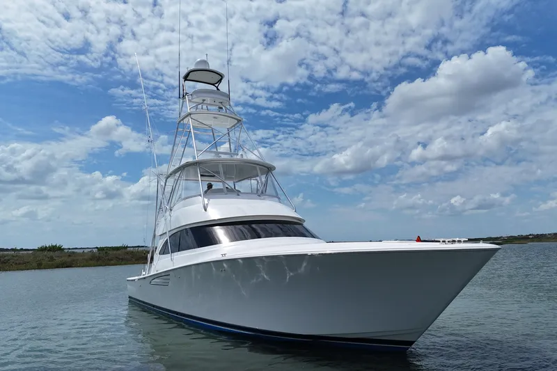 Wildcatter Yacht Photos Pics 2017 Viking 55 Convertible yacht on calm water under a partly cloudy sky.
