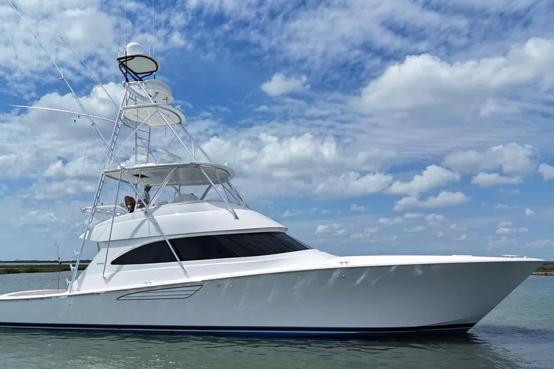 Wildcatter Yacht Photos Pics 2017 Viking 55 Convertible yacht on water under blue sky with clouds.
