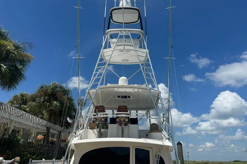 Wildcatter Yacht Photos Pics 2017 Viking 55 Convertible yacht with tower against blue sky and palm trees.