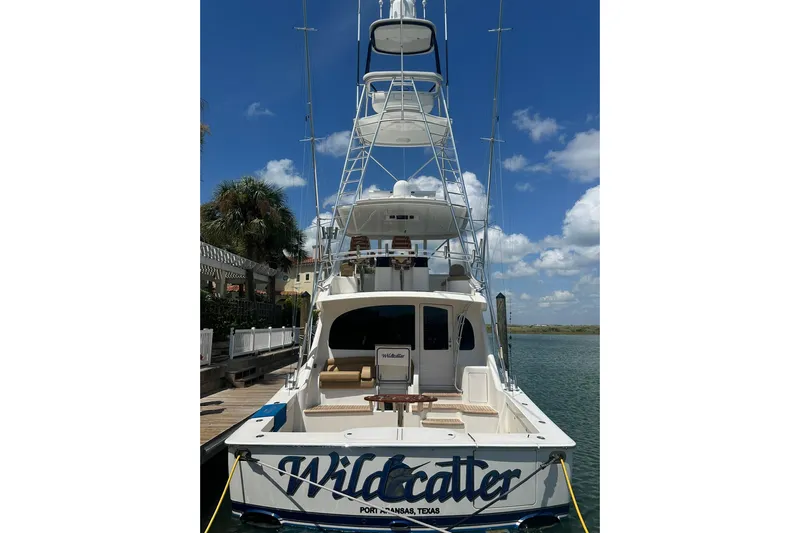 Wildcatter Yacht Photos Pics 2017 Viking 55 Convertible yacht docked, featuring "Wildcatter" name, clear sky background.