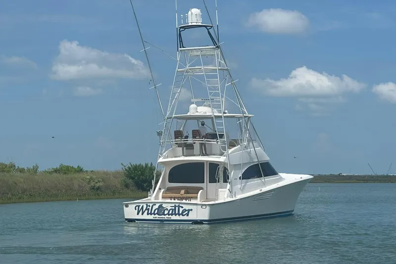Wildcatter Yacht Photos Pics 2017 Viking 55 Convertible yacht on calm water under blue sky.
