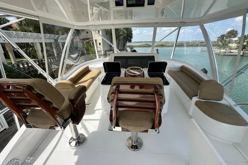Wildcatter Yacht Photos Pics Luxurious interior of 2017 Viking 55 Convertible yacht with helm and seating area.