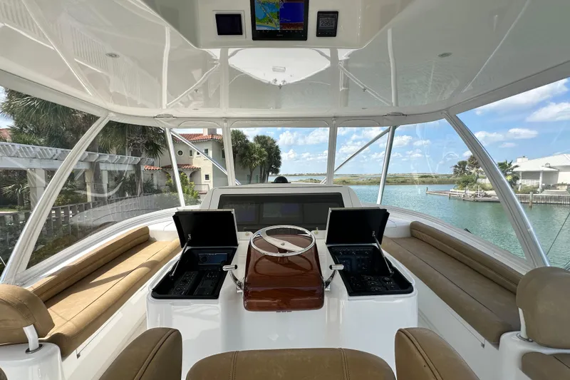 Wildcatter Yacht Photos Pics Interior view of 2017 Viking 55 Convertible yacht helm with scenic waterway backdrop.