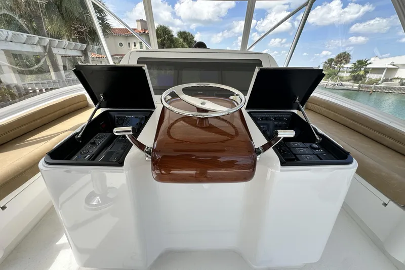 Wildcatter Yacht Photos Pics 2017 Viking 55 Convertible yacht helm with dual control panels and wooden steering wheel.